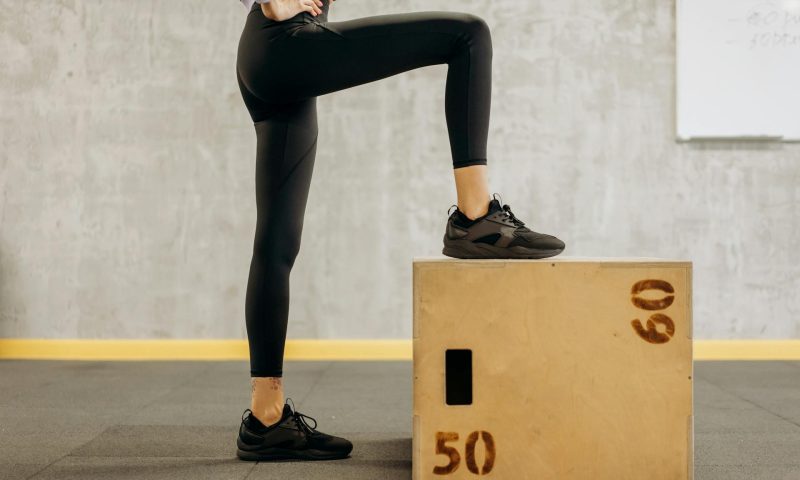 woman stepping up on box step up