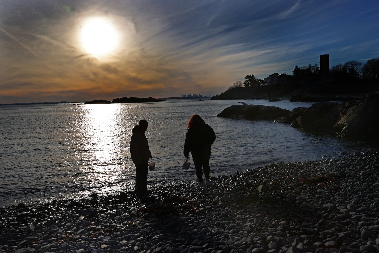 Graduate students Mica Weld and Angela Jones look for lab samples on the Nahant shoreline.